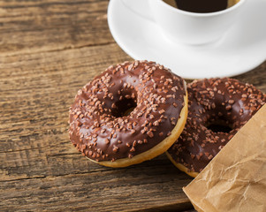 Overhead view of two tempting fresh doughnuts with their brown p