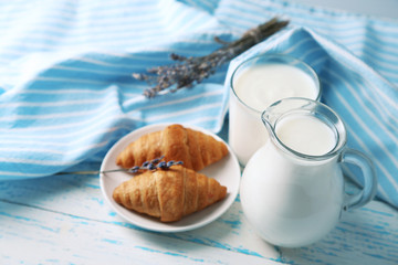 Homemade yogurt in jug and tasty croissants