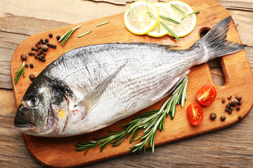 Fresh raw fish and food ingredients on table