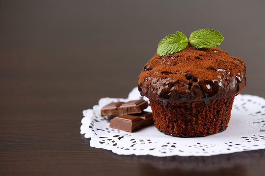 Yummy chocolate cupcake on table