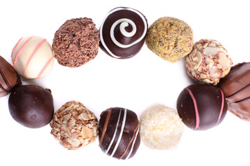 Oval from sweet truffles on white background