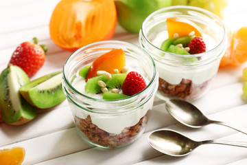 Healthy dessert with muesli and fruits on table