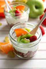 Healthy dessert with muesli and fruits on table