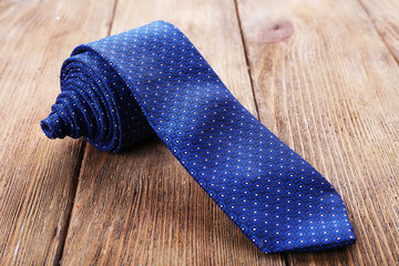 Trendy tie on wooden planks background