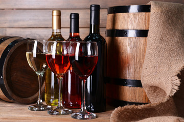 Different wine on table on wooden background