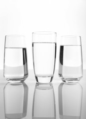 Glasses of water on light background