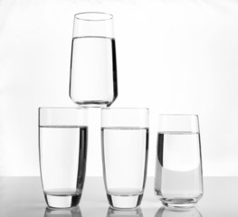 Glasses of water on light background