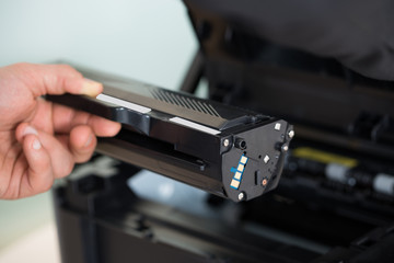Businessman Fixing Cartridge In Photocopy Machine