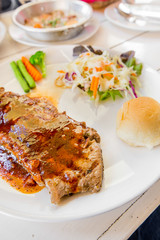 Grilled steaks,bread and vegetable salad