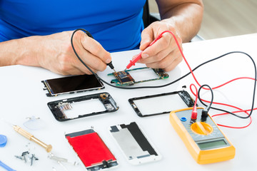 Man Repairing Cellphone