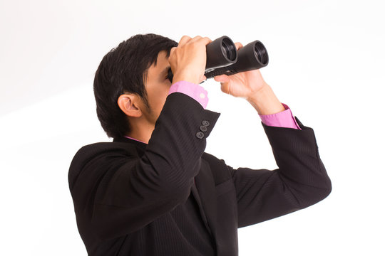 Businessman holding binoculars