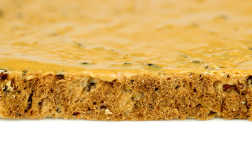 Macro closeup of edge of peanut butter toast