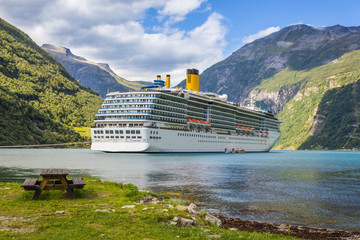 Large luxury cruise ship anchored in fjord - obrazy, fototapety, plakaty