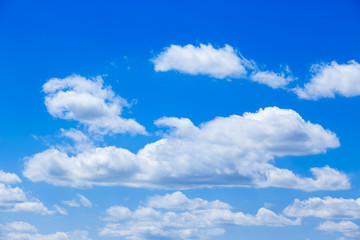 Obraz na płótnie Canvas White fluffy clouds in the blue sky