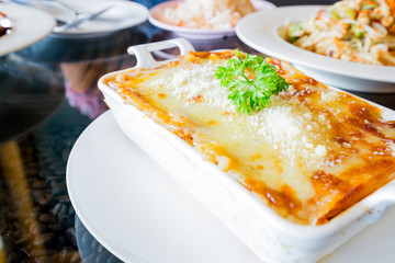 traditional lasagna made with minced beef bolognese sauce topped