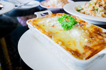 traditional lasagna made with minced beef bolognese sauce topped
