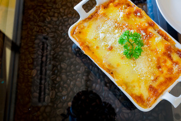 traditional lasagna made with minced beef bolognese sauce topped