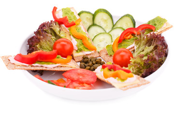 Crackers with fresh vegetables and cheese
