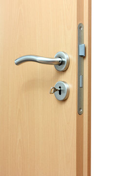 Modren style door handle on natural wooden door.