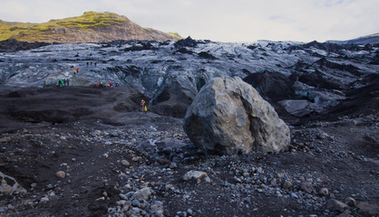 Iceland Glacier with a group of hikers hiking tourists climbing