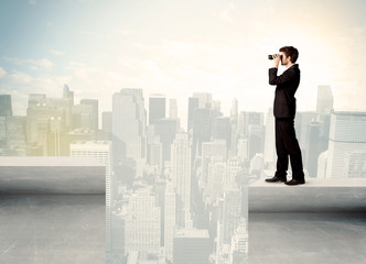 Businessman standing on the edge of rooftop