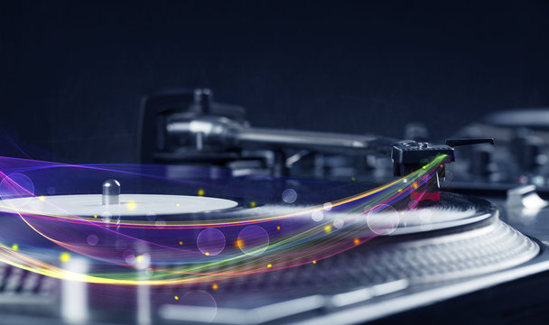 Turntable playing vinyl with glowing abstract lines
