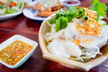 Slice steamed fish with fried garlic topping and spicy sauce.