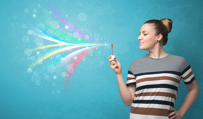 Beautiful girl blowing abstract colorful bubbles and lines