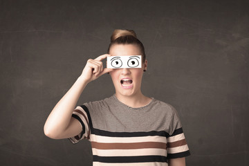 Funny woman looking with hand drawn paper eyes
