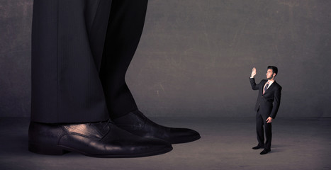Huge legs with small businessman standing in front concept