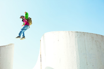brave man jumping over the concrete wall
