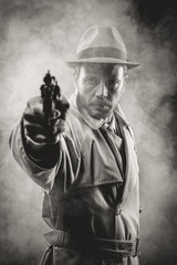 Fototapeta na wymiar Vintage agent pointing a gun