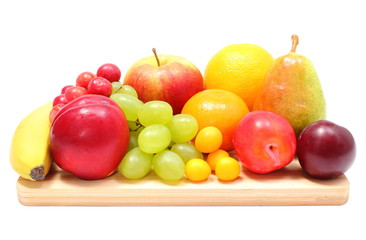 Fresh ripe fruits on wooden cutting board