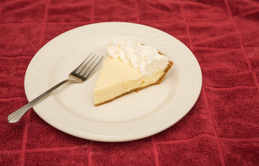 Slice of Lemon Meringue Pie on Red Towel