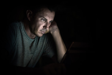 Young handsome man at laptop computer with light reflection