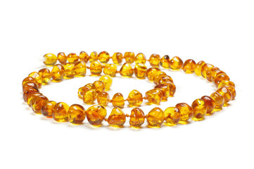 Amber necklace in spiral isolated on the white background