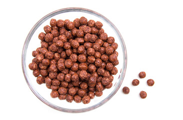 Bowl with chocolate cereal on white background top view