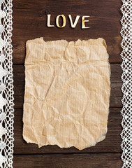 Old paper and word  Love on the wood background