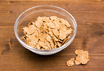 Cereals in glass bowl on wooden table