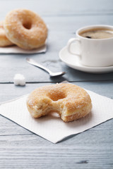 Fresh donut served with a cup of coffee