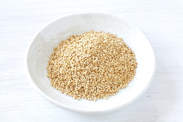 Organic natural sesame seeds on white wood table