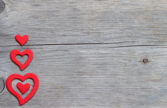 Red hearts on a wooden background