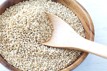 Organic natural sesame seeds on white wood table