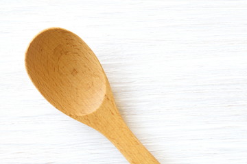 Wood brown spoon on white wood table background