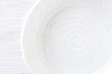 White ceramic plate asian style on white wood table