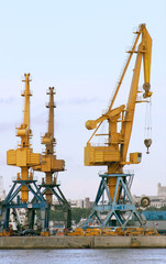 Fototapeta na wymiar Heavy cranes in the harbor