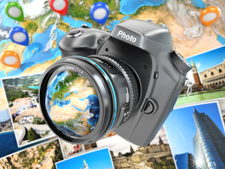 Digital photo camera on background from earth and photographs.
