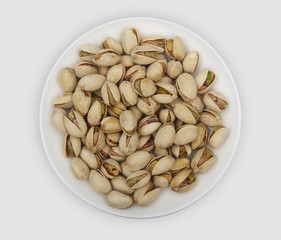 roasted pistachio nuts on a white plate