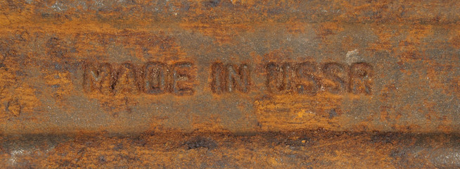 The inscription made in the USSR on a rusty metal.