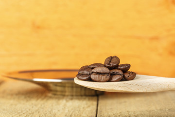 Coffee beans in a wooden spoon